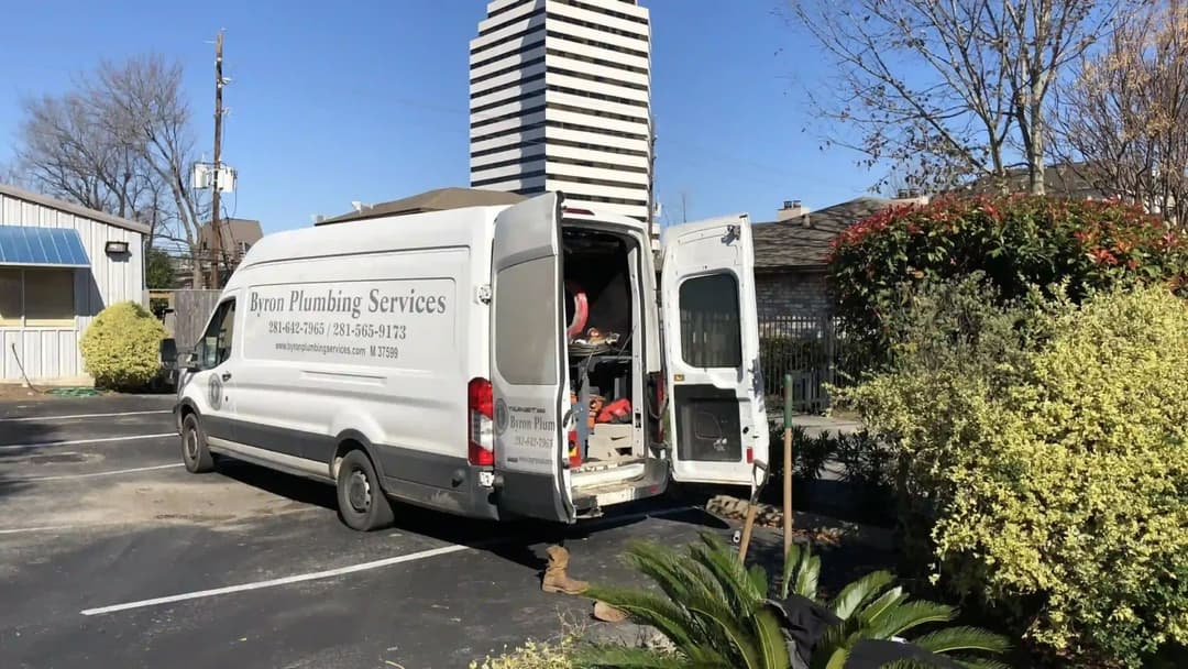 Bron Plumbing Services van parked outside, showcasing plumbing tools and equipment.